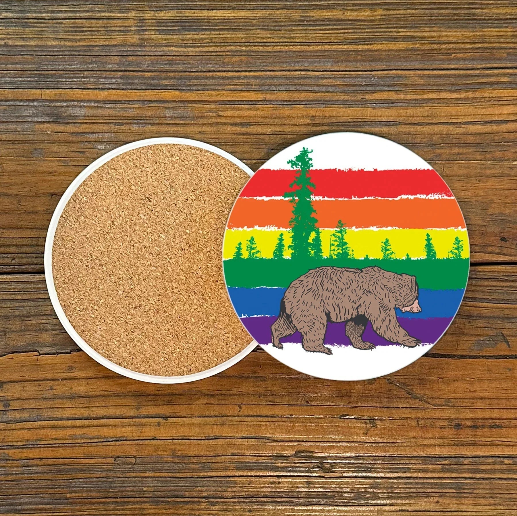 Colorful Gay Bear Drink Coaster showcasing a playful bear and rainbow scenery, perfect for adding a fun touch to your decor, 4-inch ceramic coaster.