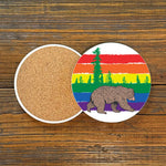 Colorful Gay Bear Drink Coaster showcasing a playful bear and rainbow scenery, perfect for adding a fun touch to your decor, 4-inch ceramic coaster.