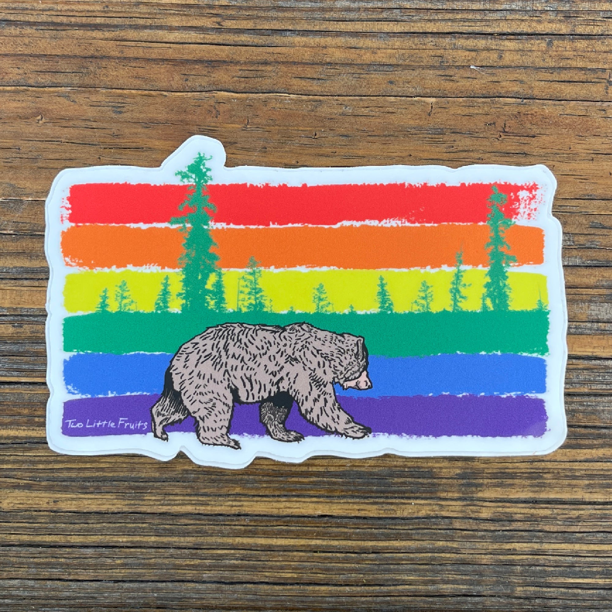 Gay Pride Rainbow Sticker featuring a cute brown bear walking on a vibrant rainbow stripe background, perfect for adding flair to your belongings. Great addition for anyone loving gay pride stickers!