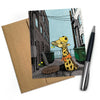 Giraffe Greeting Card featuring a cheerful illustration of a giraffe in a construction helmet in an alley, showcasing cute animal cards from Two Little Fruits.