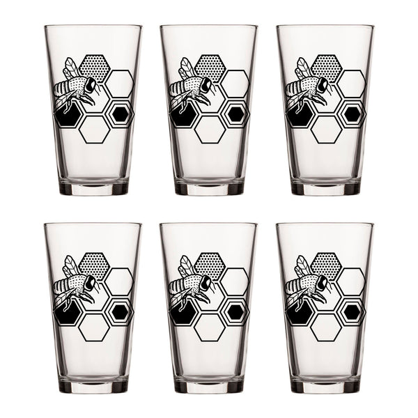 Set of bee beer glasses arranged in a stylish display, showcasing their artistic bee and honeycomb graphics.