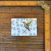 Close-up of the Hummingbird Fridge Magnet next to a ruler, emphasizing its size and intricate detail for a decorative touch.