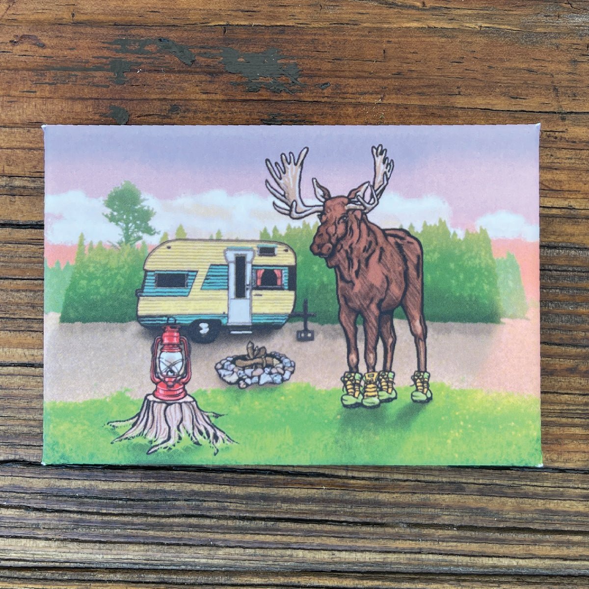 Moose In Boots Fridge Magnet featuring a playful moose standing by a camper, perfect for adding fun to your kitchen with moose themed decor.