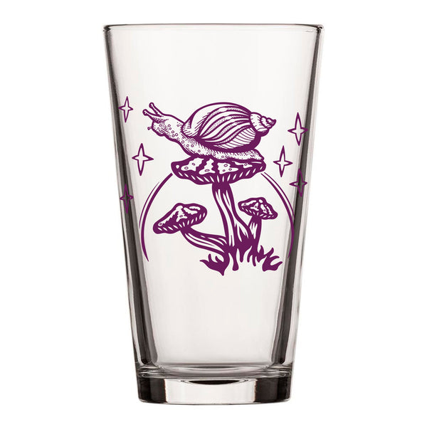 A clear mushroom pint glass featuring vibrant artwork of a purple snail atop a mushroom, ready for your favorite refreshing beverages.