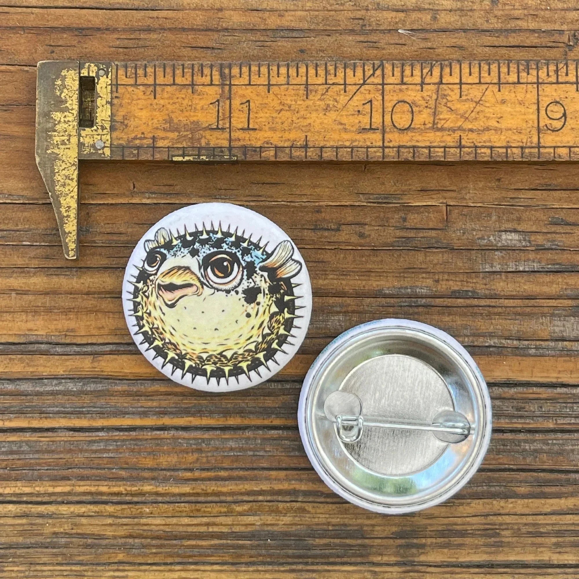Pufferfish illustrated button pin by Two Little Fruits