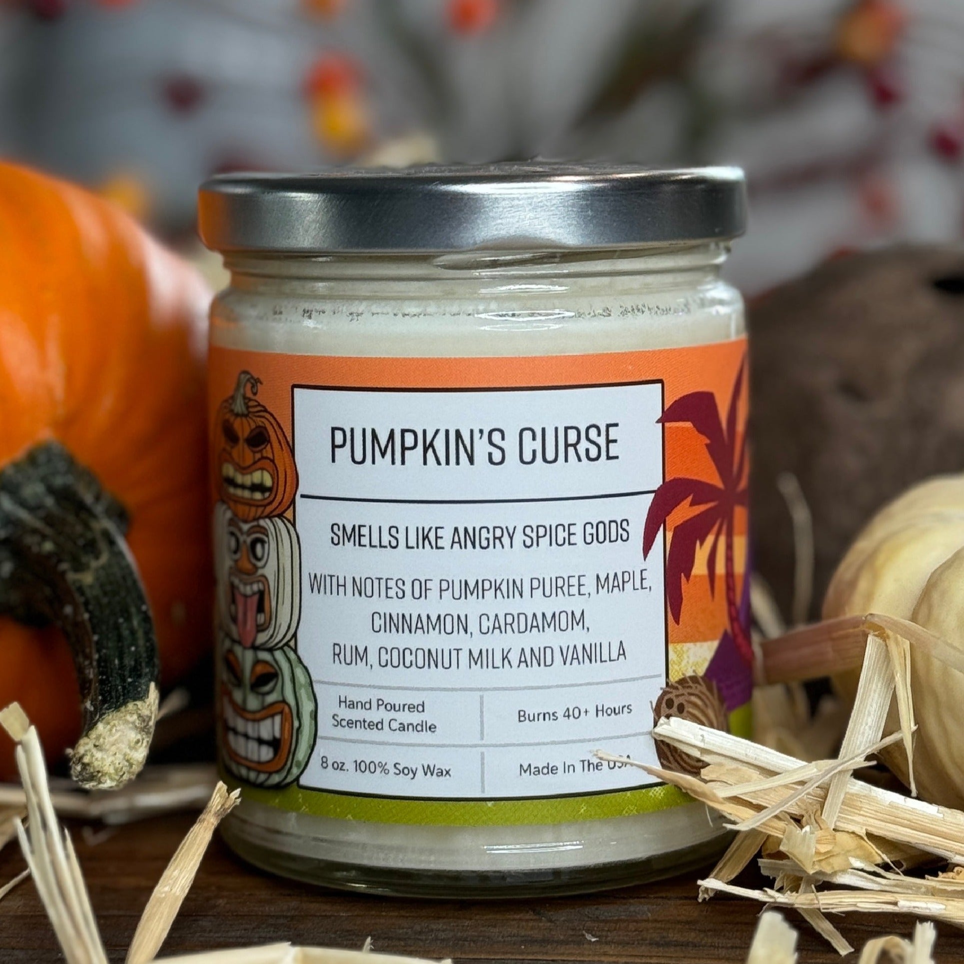 Pumpkin Spice Scented Soy Candle by Two Little Fruits, showcasing the label 'Pumpkin's Curse'. A cheerful design highlights the scent notes of pumpkin puree, maple, and cinnamon, surrounded by autumn decor. Perfect for pumpkin spice candles enthusiasts.