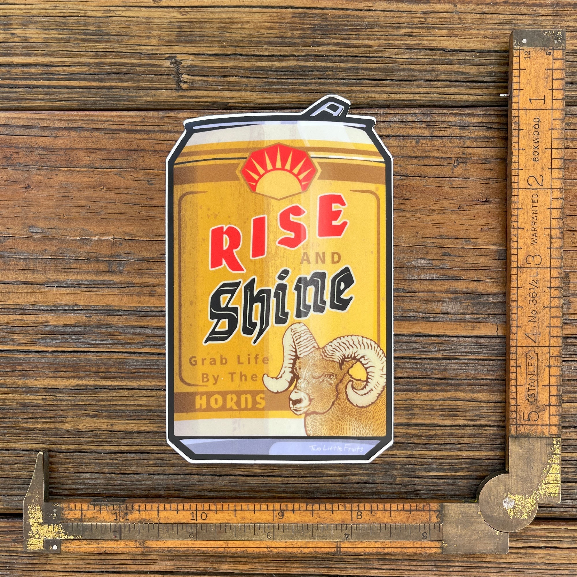 Colorful beer can sticker featuring a bighorn sheep design with the text 'Rise and Shine', perfect for personalizing your belongings.