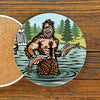Bright Sasquatch Drink Coaster featuring a fun illustration of a cheerful Sasquatch holding fish, perfect for adding character to your coffee table. A great choice for unique coffee table coasters.