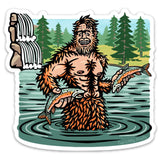 Sasquatch Sticker design depicting a cheerful Sasquatch holding fish in a river, with a lush forest in the background, created by Two Little Fruits.