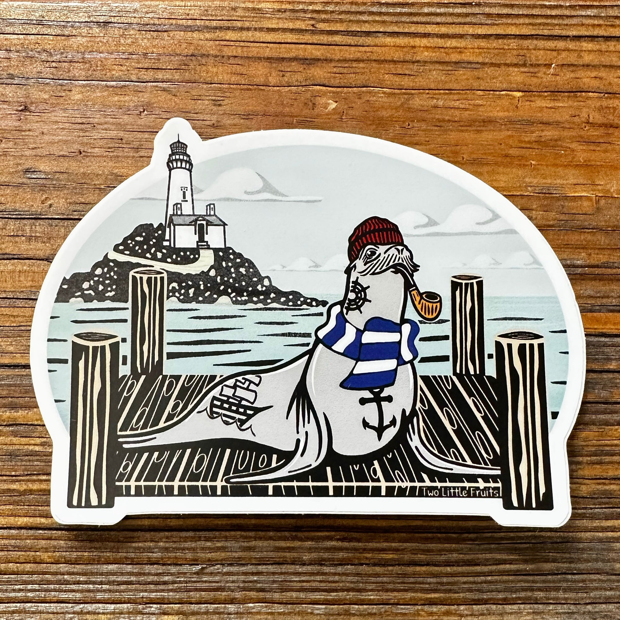 Cheerful Sea Lion Sticker featuring a sailor sea lion wearing a red beanie and blue striped shirt, sitting on a wooden dock with a lighthouse in the background. Perfect for adding personality to your belongings!