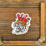 Unique Tiger Sticker design showcasing a tiger wearing a crown, holding toilet paper, ideal for adding flair to your belongings.
