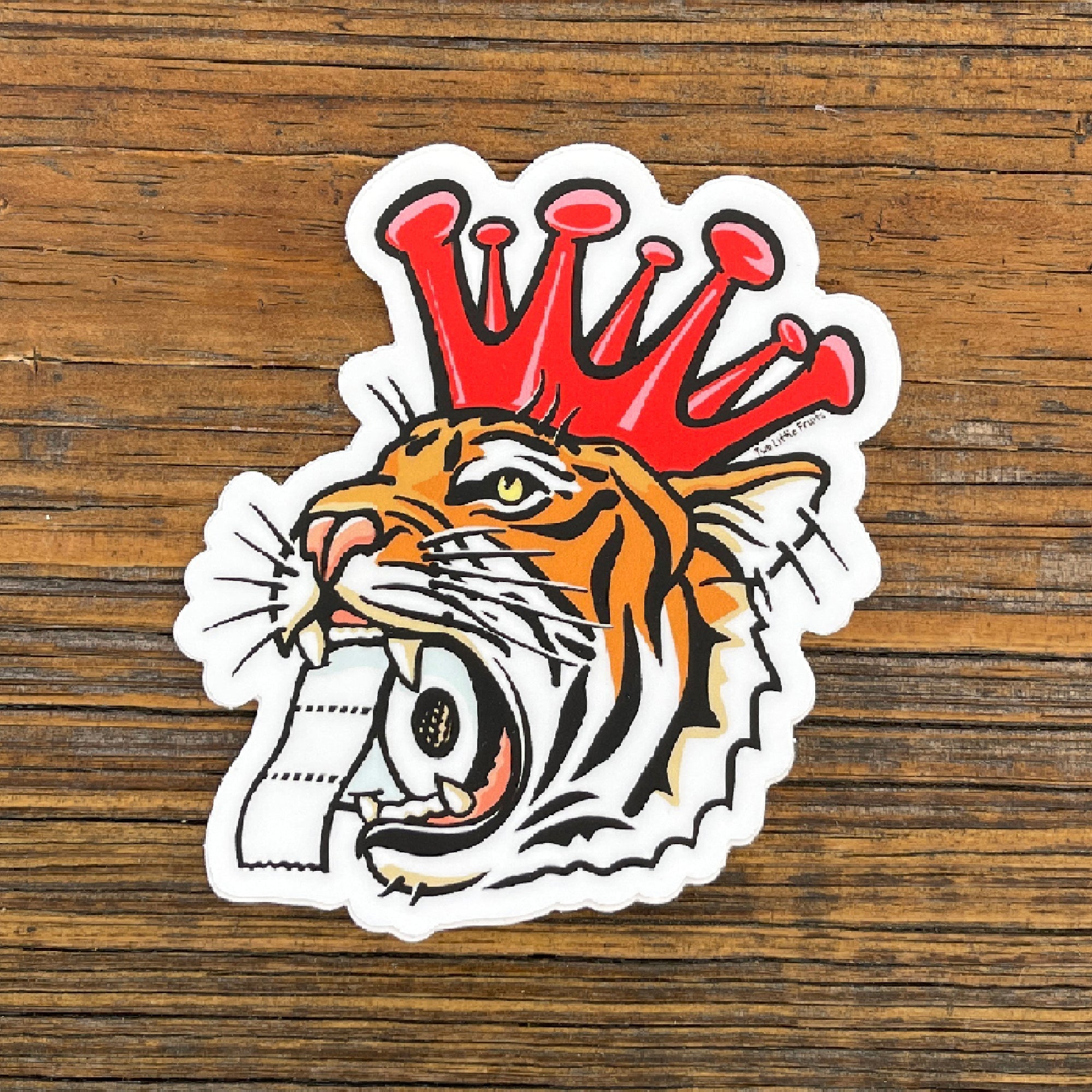 Cheerful Tiger Sticker featuring a tiger with a coronavirus crown and toilet paper in its mouth, perfect for personalizing any item.