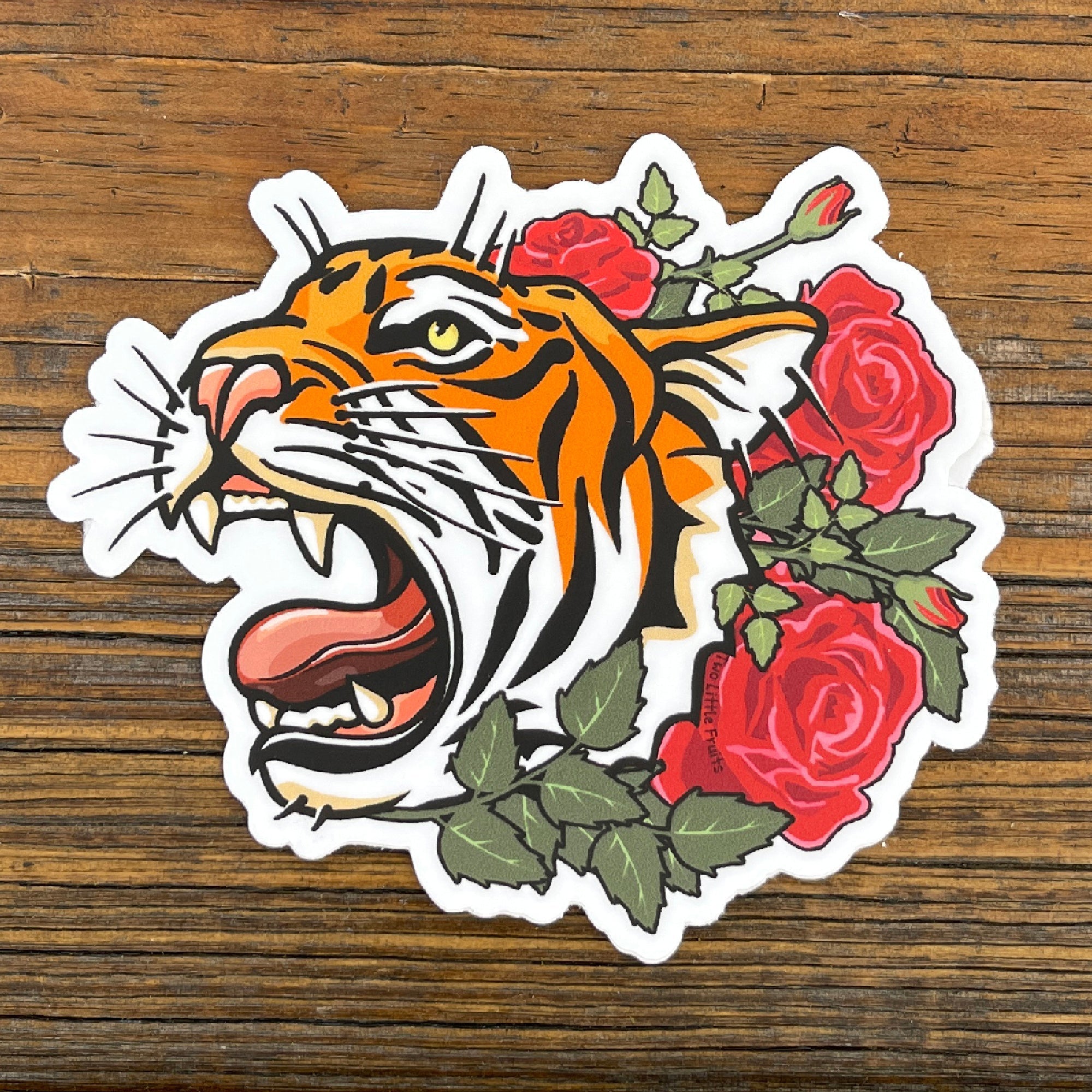 Tiger Sticker featuring a roaring tiger surrounded by vibrant red roses, perfect for adding flair to your personal items.