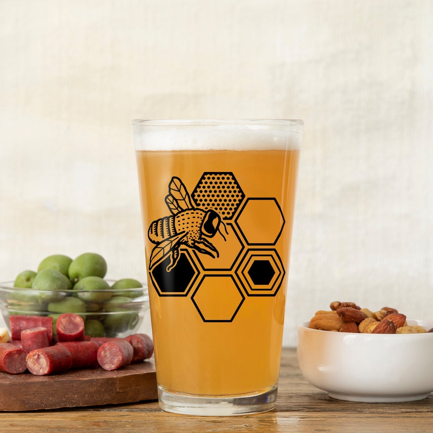 Unique Beer Glass Set featuring a bee and hexagon design, perfect for craft beer lovers. Enjoy your drinks with style using these 16 oz pint glasses.